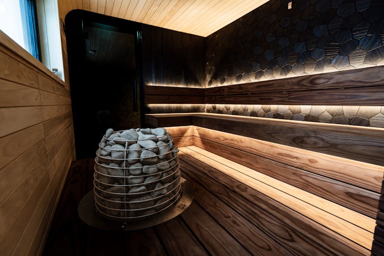 Elegant indoor sauna featuring warm wood textures and modern design elements, ideal for relaxation.